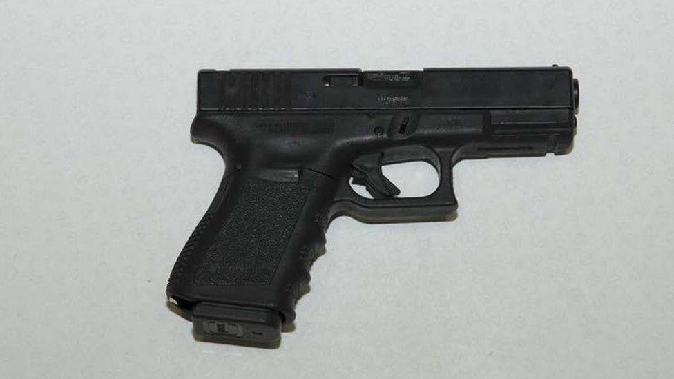 One of the firearms discovered in a concealed compartment at the back of the Honda car.