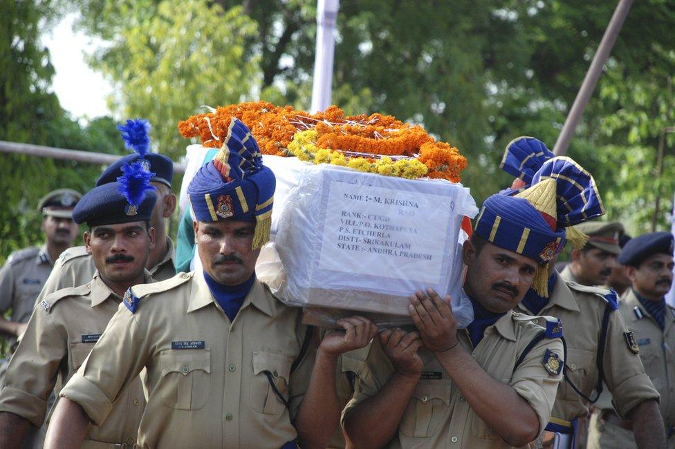 Indian soldiers carry the coffin of a colleague following the deaths of 26 soldiers in a Maoist ambush.