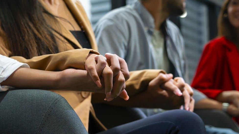 A group of people holding hands