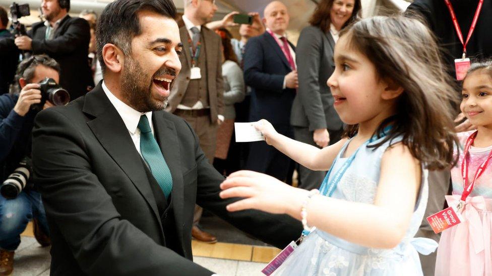 Humza Yousaf hugs his daughter Amal, 3, at the Scottish Parliament.