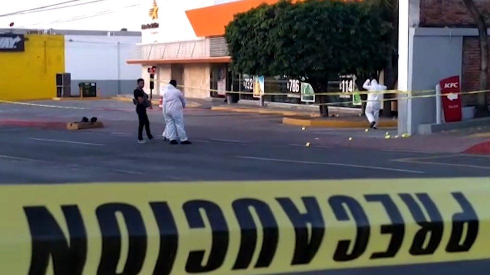 Grab taken from an AFPTV video showing police forensic researchers going through the crime scene at a bus station where armed gunmen killed at least five people and injured one in Cuernavaca, in the Mexican central state of Morelos, on September 2, 2019.