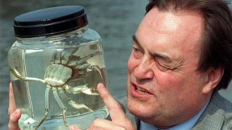 John Prescott in 1997 holding a jar with what appears to be a crab inside 