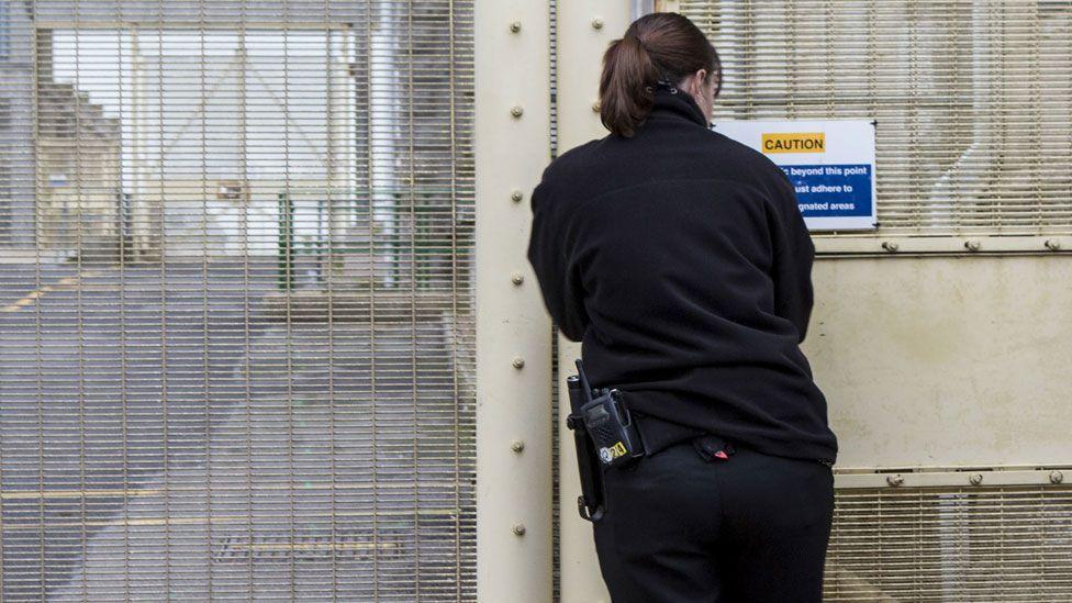 A prison officer walking through the prison at HMP/YOI Portland, Dorset.