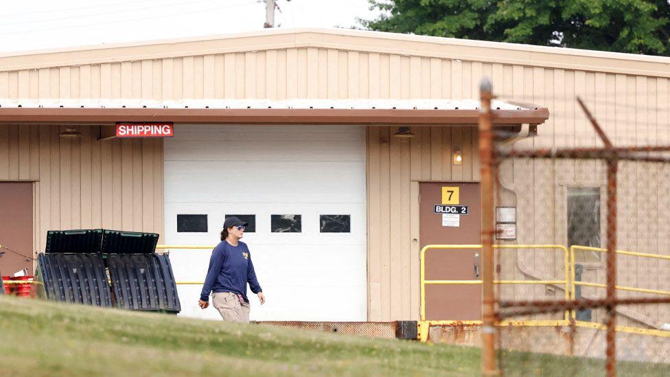 A member of the FBI Evidence Response Team, works near the building where a gunman was shot dead by law enforcement, near the stage where Republican presidential candidate and former U.S. President Donald Trump survived an assassination attempt during a rally the day before, in Butler, Pennsylvania, U.S. July 15, 2024.