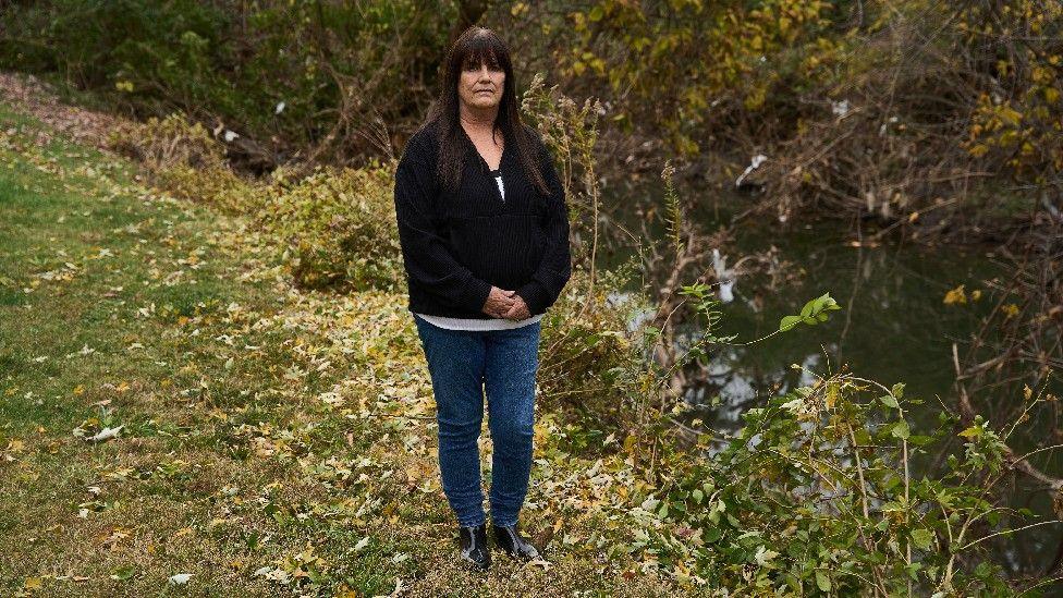 Karen Nickel stands in front of Coldwater Creek