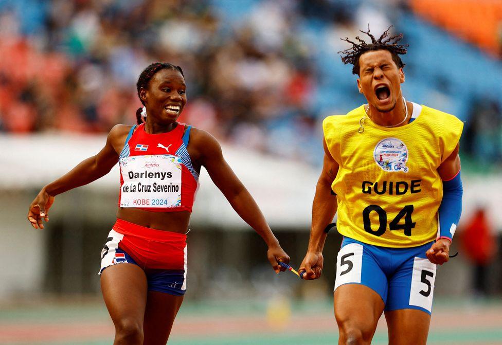 Darlenys de la Cruz Severino of Dominican Republic and her guide celebrate winning the gold medal after competing in the Women's 100m T12 final during day seven of the World Para Athletics Championships Kobe at Kobe Universiade Memorial Stadium on May 23, 2024 in Kobe, Hyogo, Japan. 