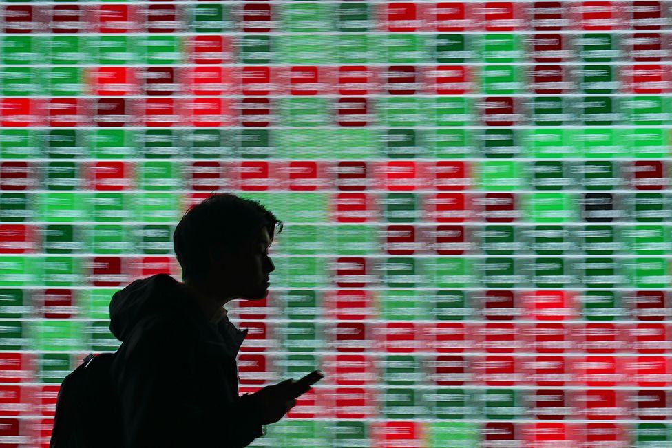 An electronic board displays stock figures outside a securities firm in Tokyo, Japan, on Tuesday, Jan. 28, 2025.