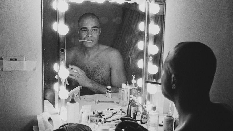 James Earl Jones looking at his reflection in a mirror before going on stage to appear in the play The Great White Hope in 1970