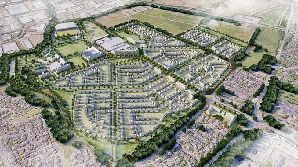 Artist's impression of the future of the East of England Showground in Peterborough. Aerial view of hundreds of houses and other buildings ringed by fields and trees.