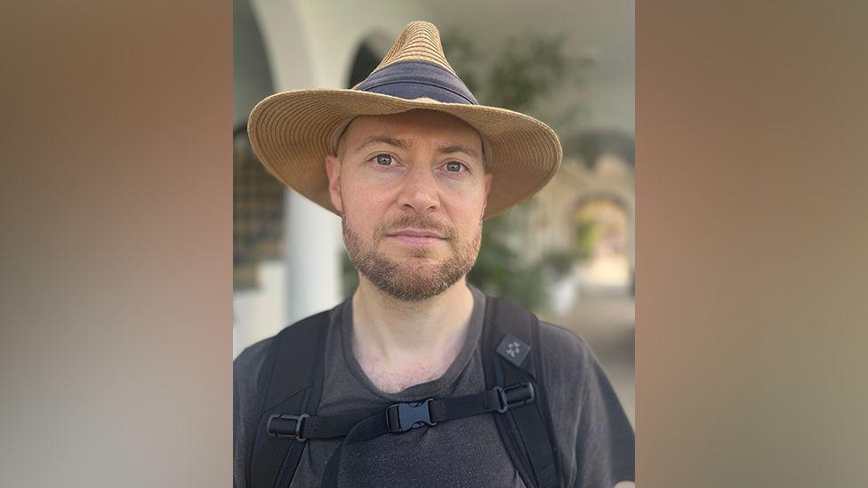 Martin Batty wearing a wide-brimmed hat