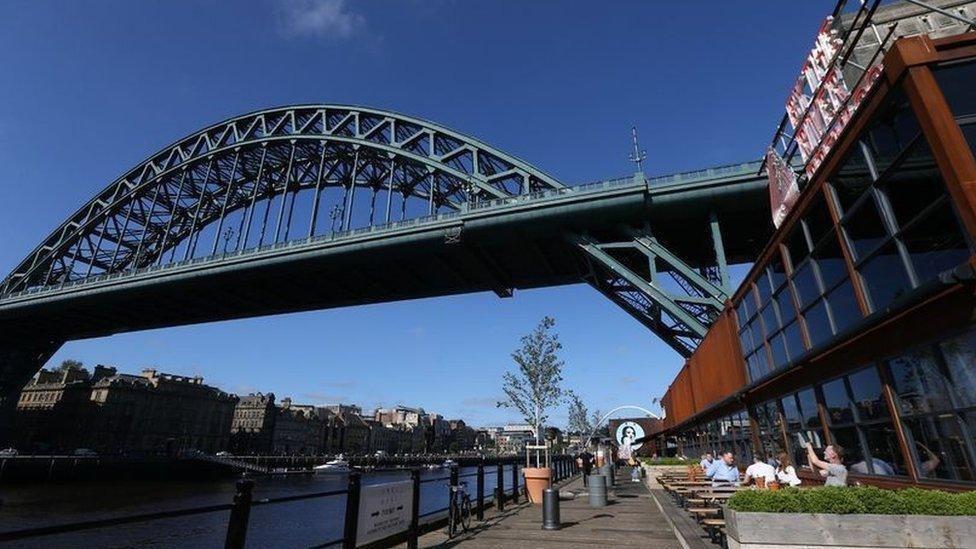 A picture of By The River Brew with the Tyne Bridge in the background.