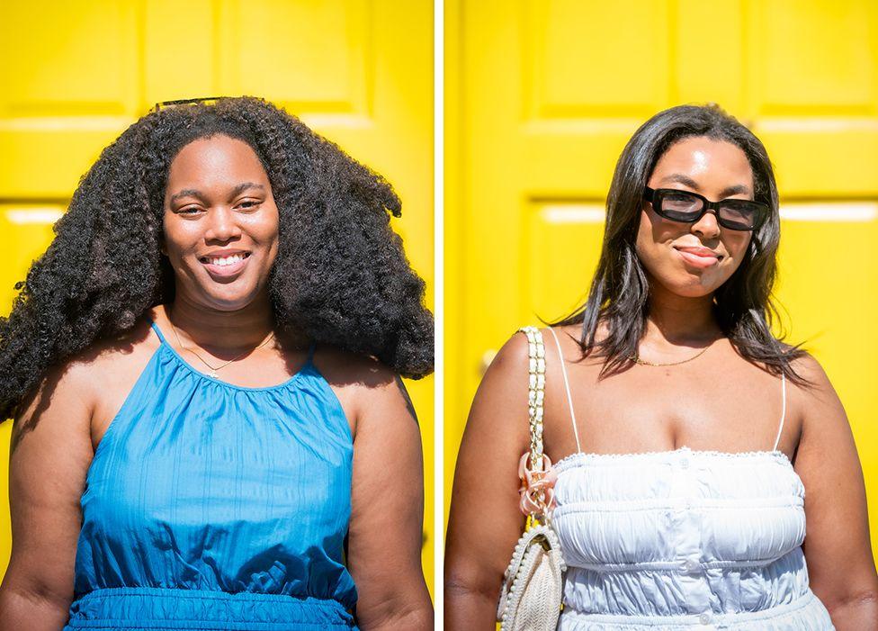 Sky and Chantelle, two young women with dark brown hair smile to the camera in front of a yellow door