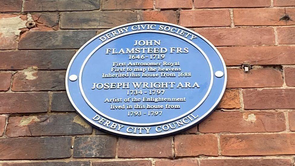 Plaque on the side of 27-28 Queen Street with Joseph Flamsteed and Joseph Wright's names on 