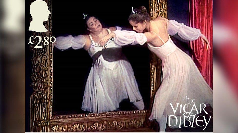 Dawn French behind a frame mimicking Dame Darcy Bussell performing the ballet in The Vicar of Dibley TV sitcom.