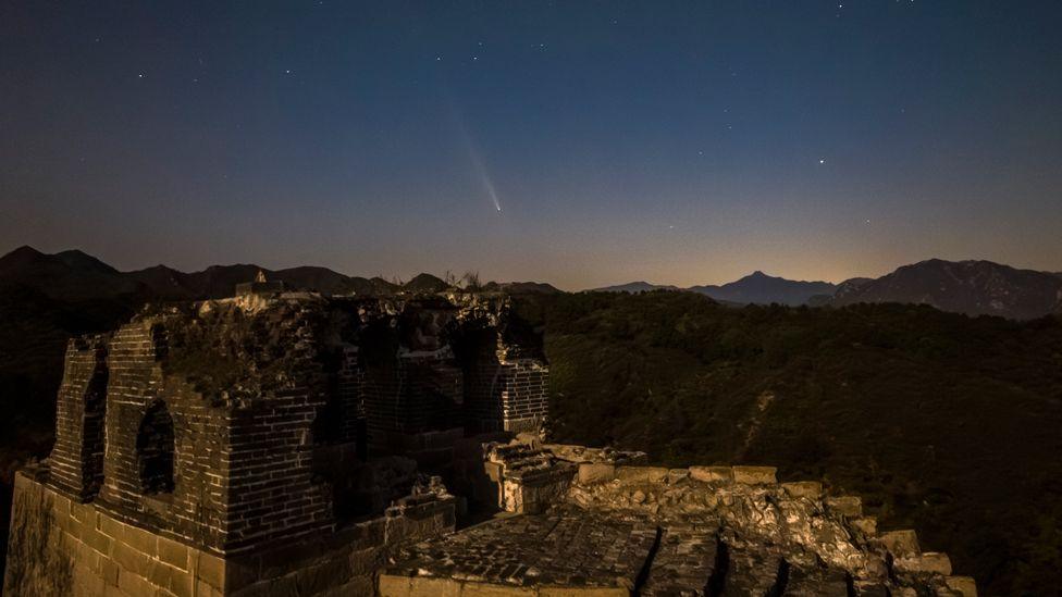 The Comet C/2023 A3 (Tsuchinshan-ATLAS) streaks across the sky over the Dazhuangke section of the Great Wall which can bee seen in the foreground at night on October 16, 2024 in Beijing, China. 