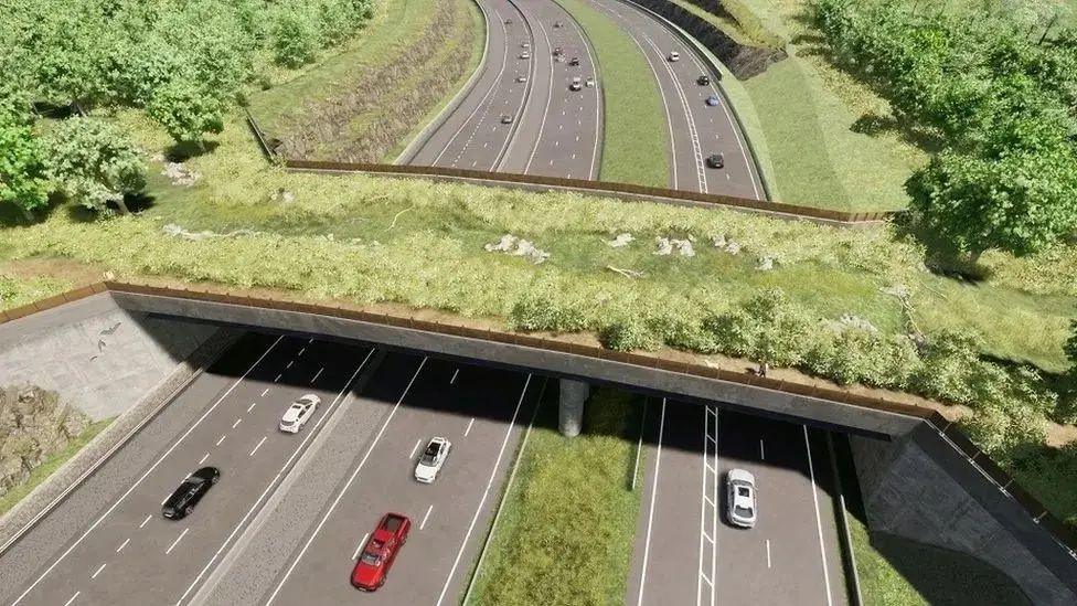 Concept image of the Missing Link project. Roads can be seen underneath a green bridge. Cars are driving along the roads in both directions. 