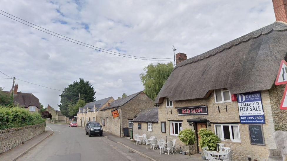 Church Street, Stratton Audley, with The Red Lion pub on the right