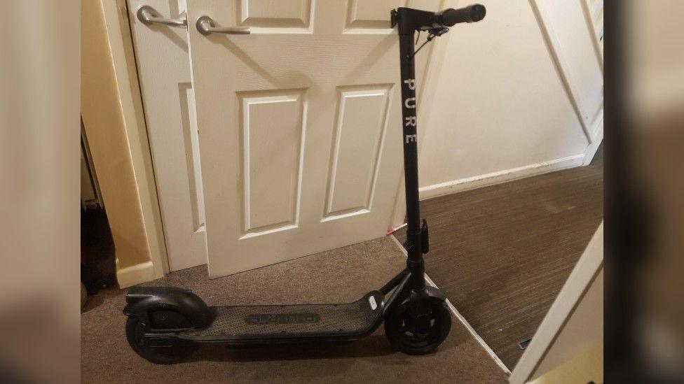 An image of a black e-scooter