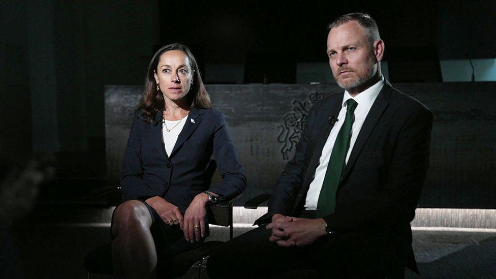 Rebecca Weiner and Matt Jukes sit on chairs during an interview