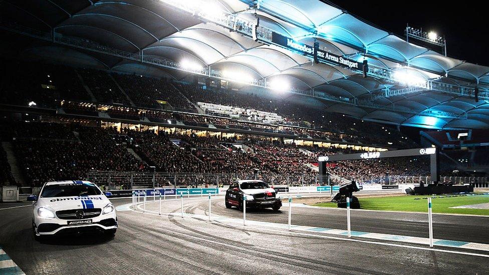 Lewis Hamilton of Great Britain races Mika Hakkinen of Finland in the first round of races in the Mercedes-AMG A 45 of the Stars and Cars event at Mercedes-Benz Arena on 12 Dec 2015 in Stuttgart