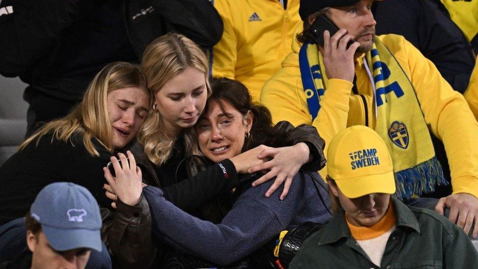 Swedish supporters react as they wait in the stand during the Euro 2024 qualifying football match between Belgium and Sweden at the King Baudouin Stadium in Brussels on 16 October