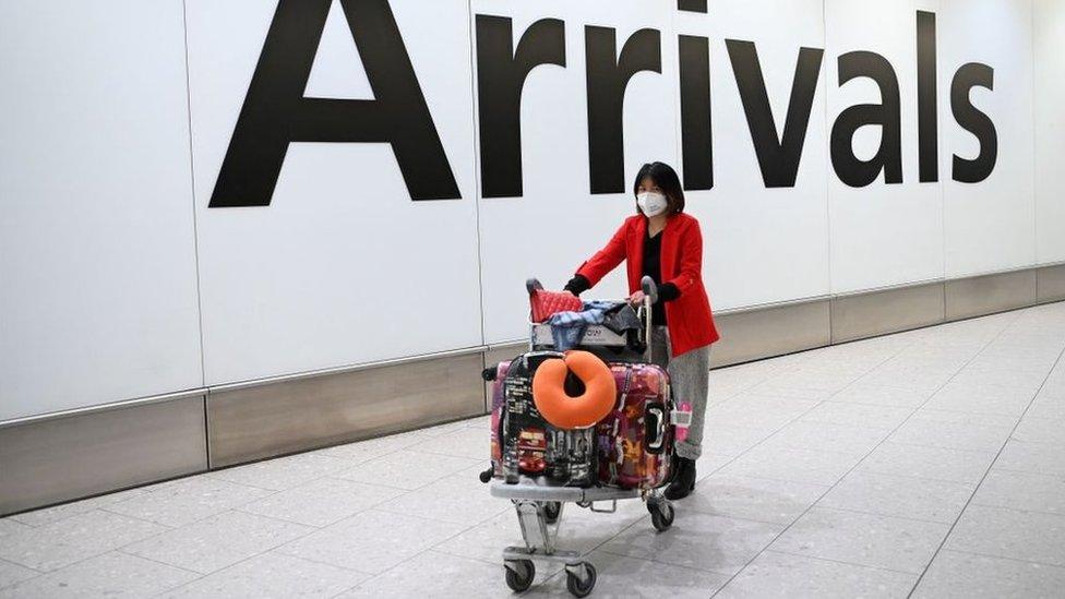 A woman arrives at Heathrow