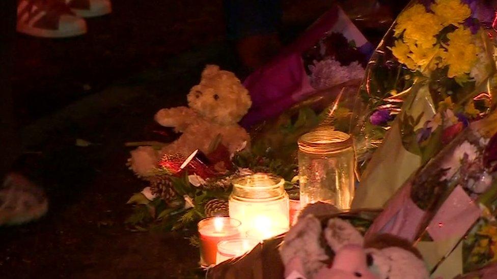 A candle and teddy at the scene