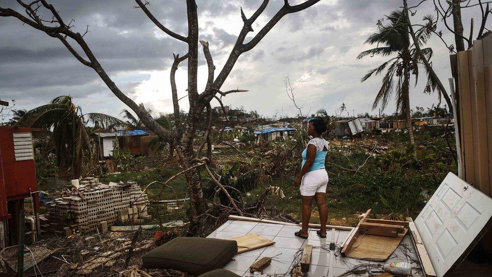 A lady stands on the remains of her damaged house in San Isidro, Puerto Rico after Hurricane Maria struck the island.