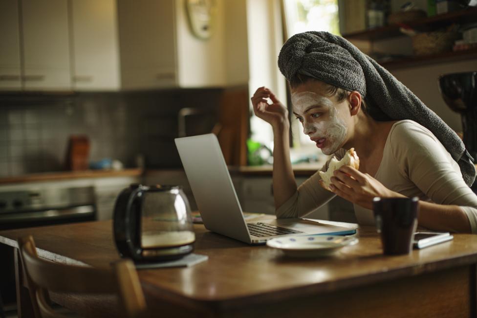 Woman at kitchen table on computer