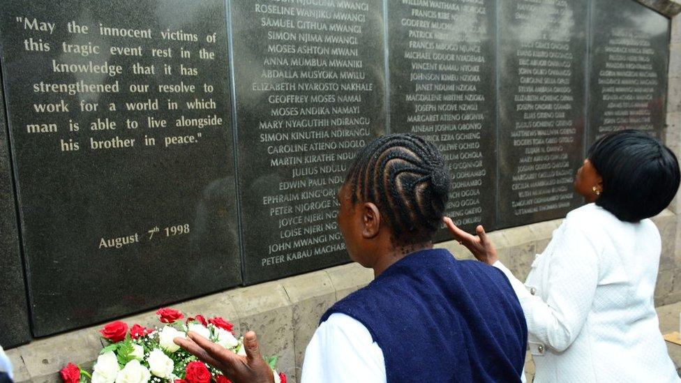 People praying at a amemorial