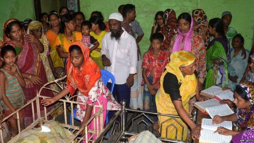 Bangladeshi relatives surround the bodies of some of those killed in a stampede