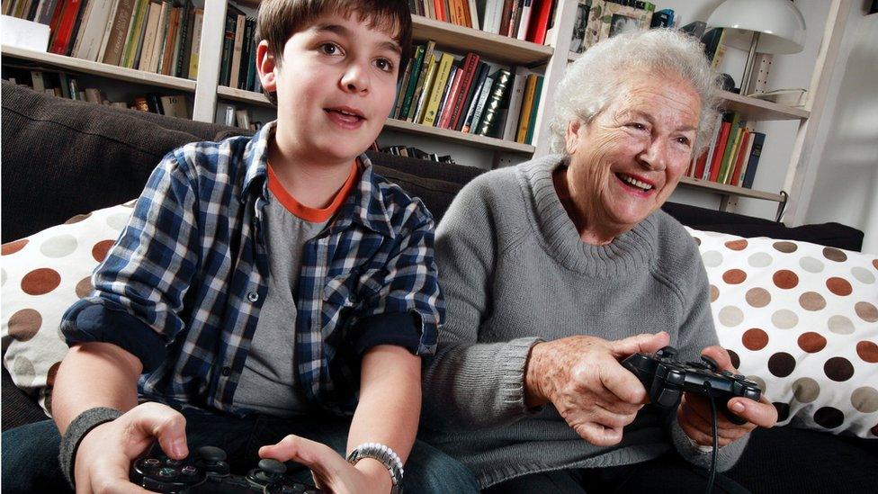 Grandmother and grandson playing computer game