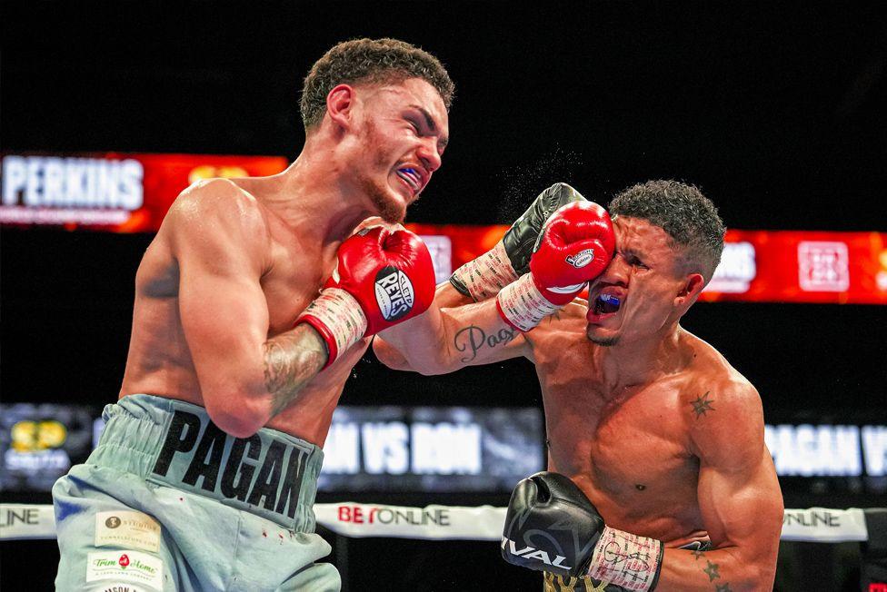 Joshua James Pagan and Ronal Ron fight in the eighth round of their lightweight boxing bout at Dort Financial Center in Flint, Michigan