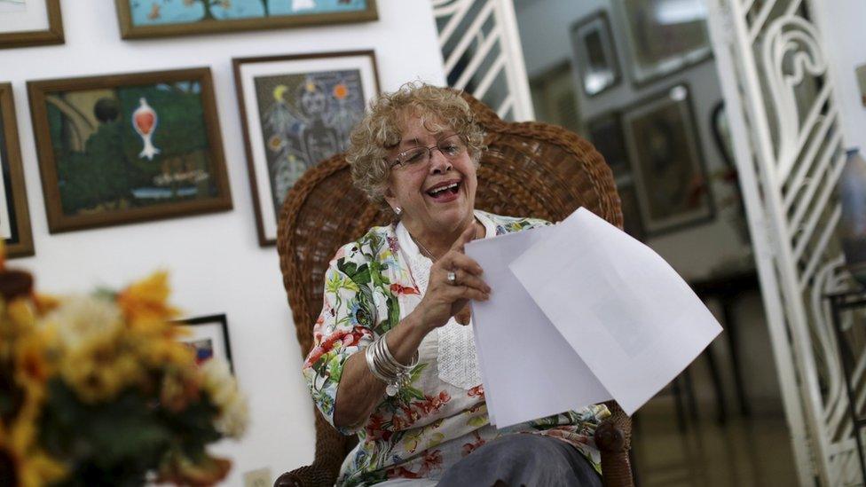 Ileana R. Yarza laughs while holding a print-out of a letter U.S. President Barack Obama is sending her via a flight carrying the first batch of U.S. direct mail to Cuba, after both countries agreed to restore direct postal service after a half-century rupture, at her home in Havana