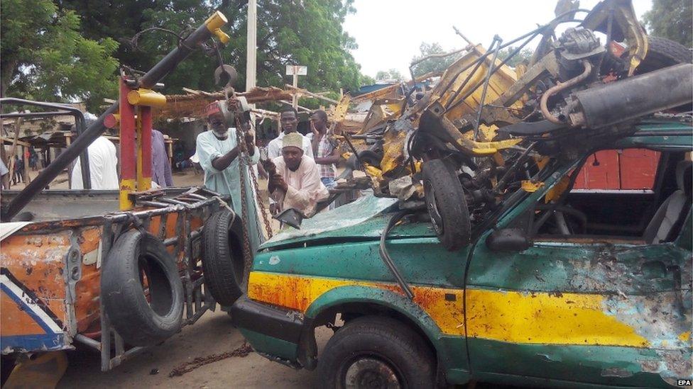 Rescue Workers tow a taxi car at the scene of a bomb blast near Gamboru vegetable market, in Maiduguri, Nigeria, 31 July 2015