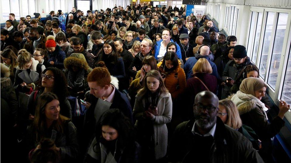 Crowds of people queuing to get on to platforms at Clapham Junction