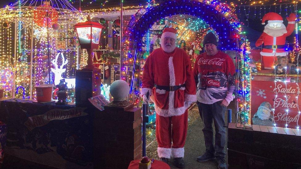 Martin Claridge in front of his house with Santa