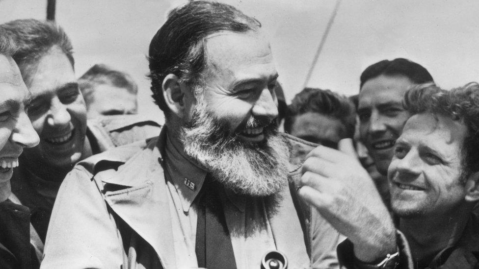 1944: American writer Ernest Hemingway (1899 - 1961) travelling with US soldiers, in his capacity as war correspondent, on their way to Normandy for the D-Day landings.