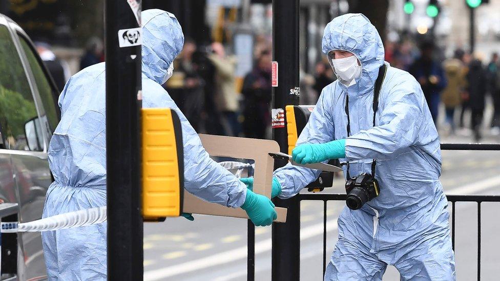 Forensics officers handling a knife