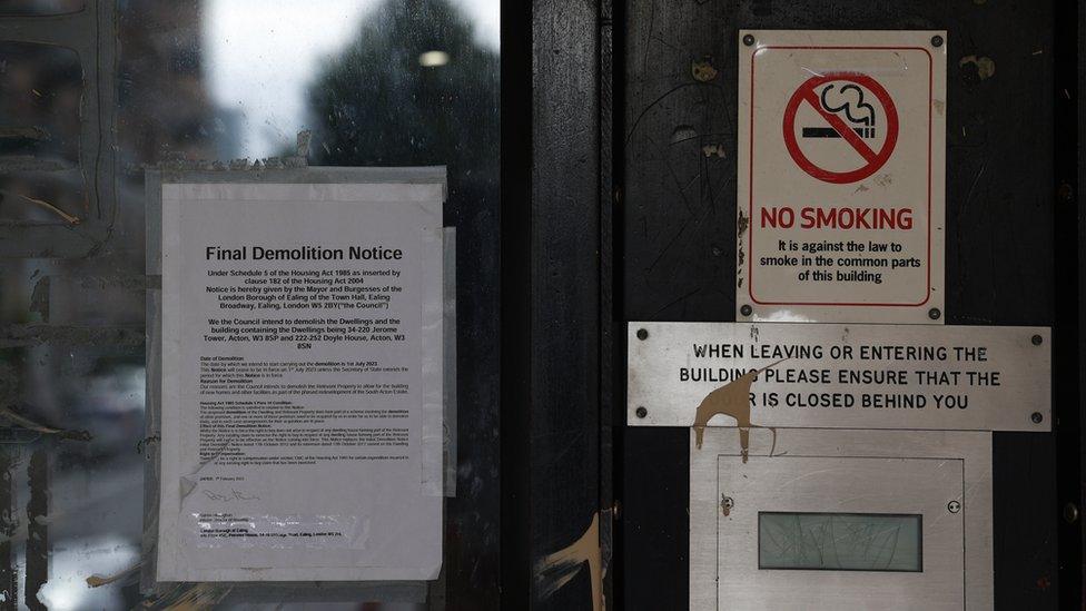 A notice of demolition has been stuck to the glass panel of a door