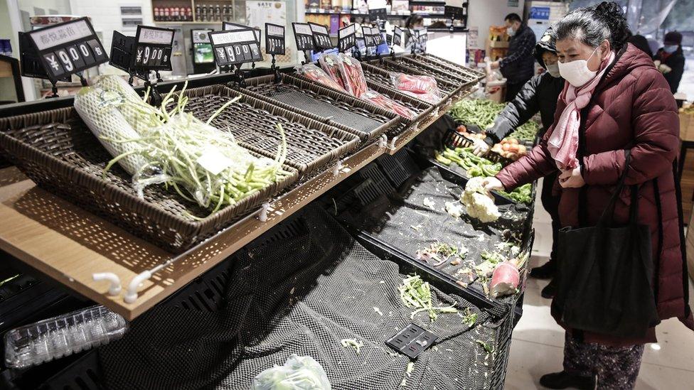 Empty supermarket shelves in Wuhan