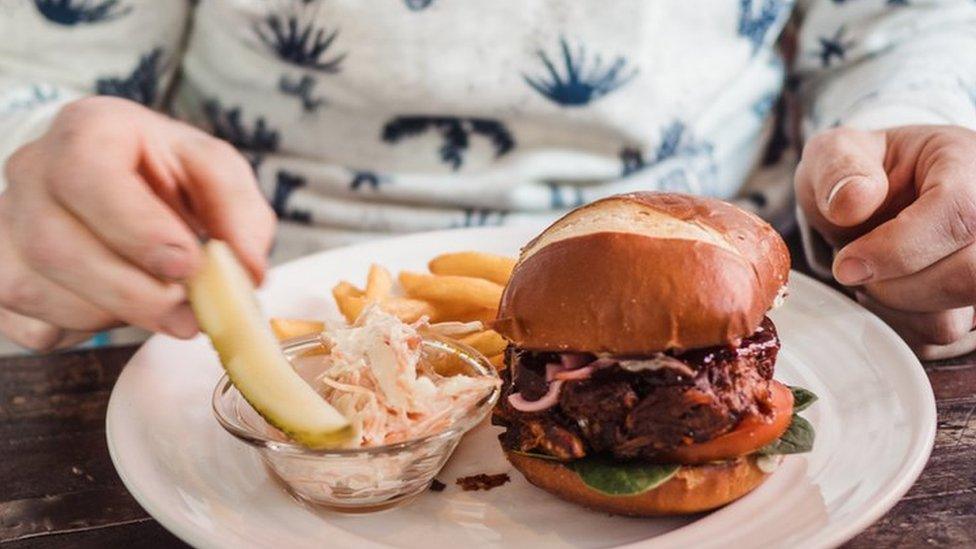 Man eating vegan burger