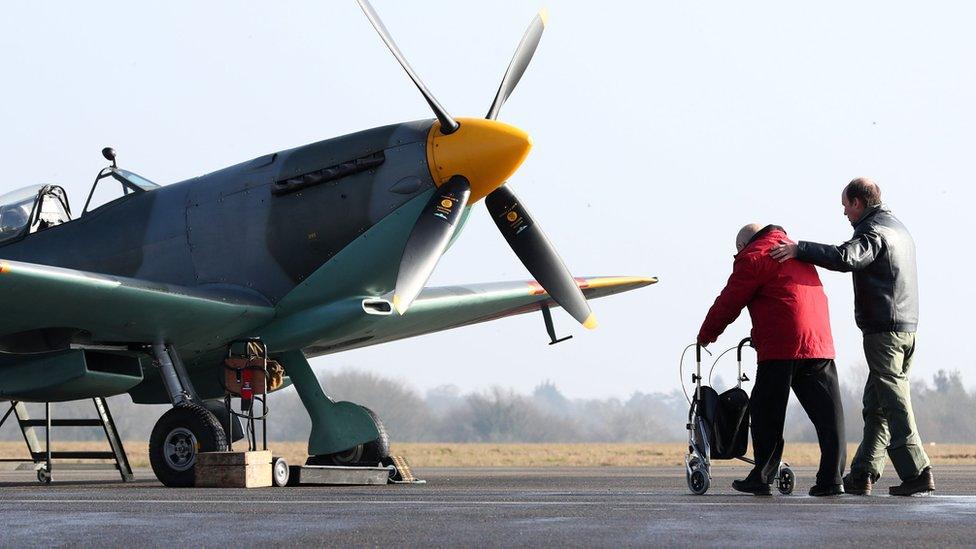 Former Spitfire pilot Ray Roberts is led to a Spitfire by Captain Peter Kynsey at the launch of the celebrations the mark the centenary of Biggin Hill airport