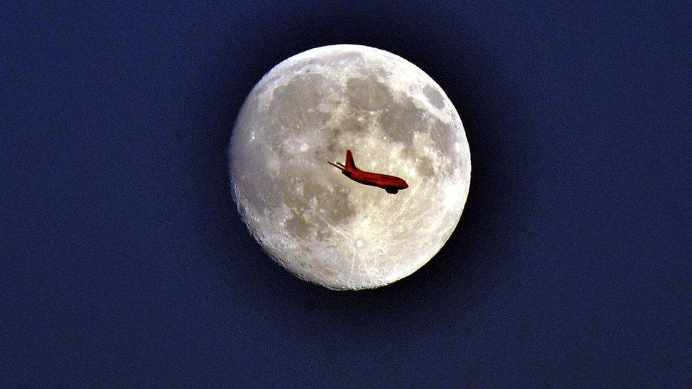 Plane in front of the moon