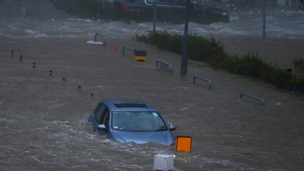 A car is stranded in seawater as high waves hit the shore during Typhoon Mangkhut at Heng Fa Chuen in Hong Kong, China on 16 September 2018.