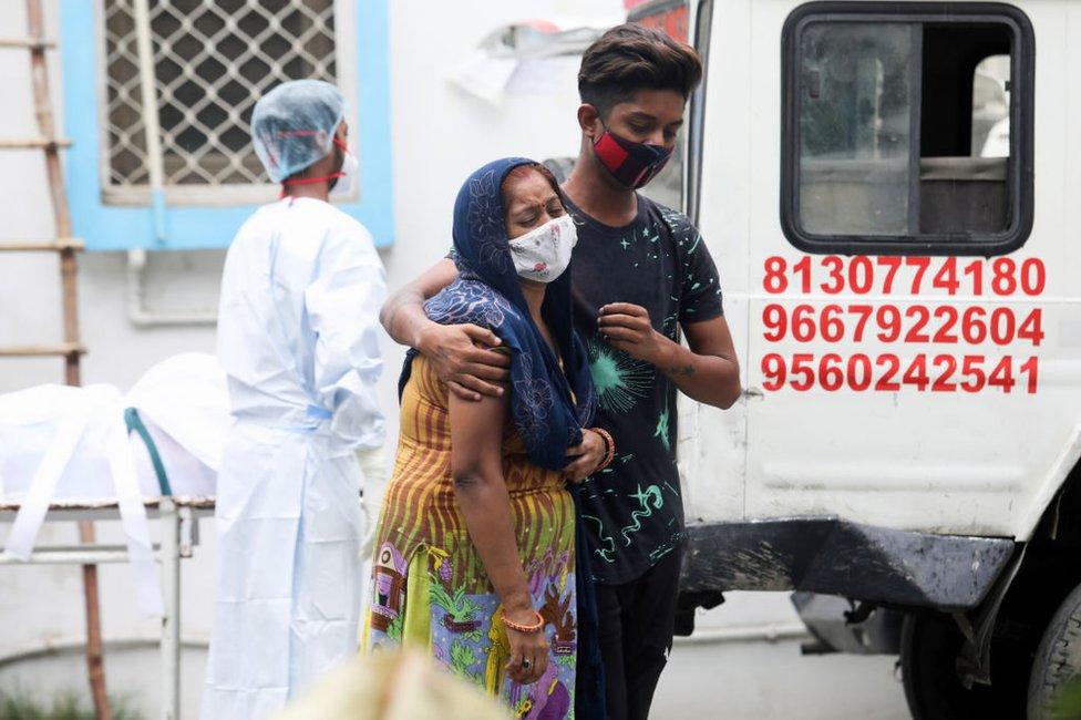 A woman mourns the death of a family member due to Covid-19 coronavirus disease outside the LNJP (Lok Nayak Jai Prakash Narayan) Hospital