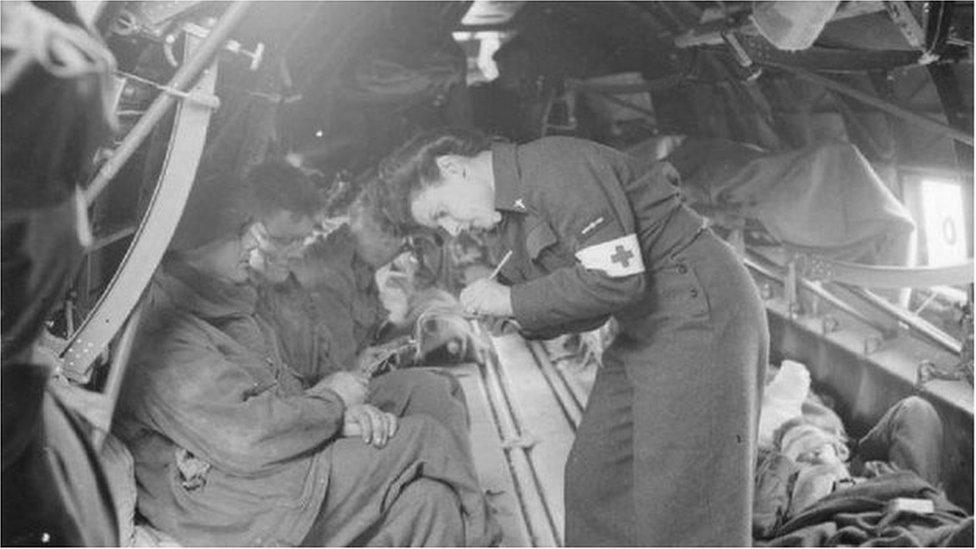 A nurse treating soldiers