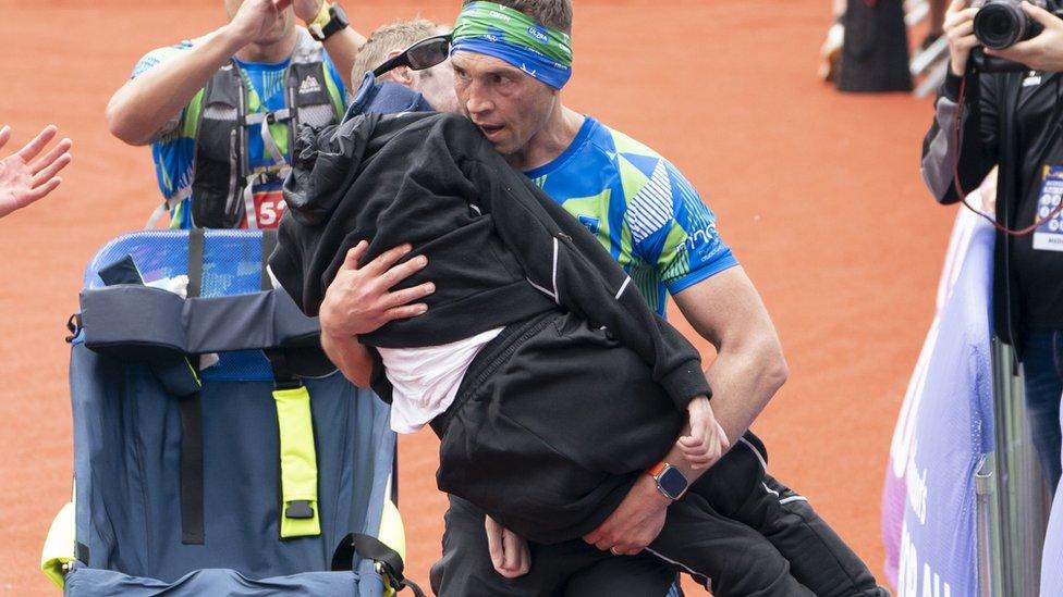 Kevin Sinfield carrying Rob Burrow