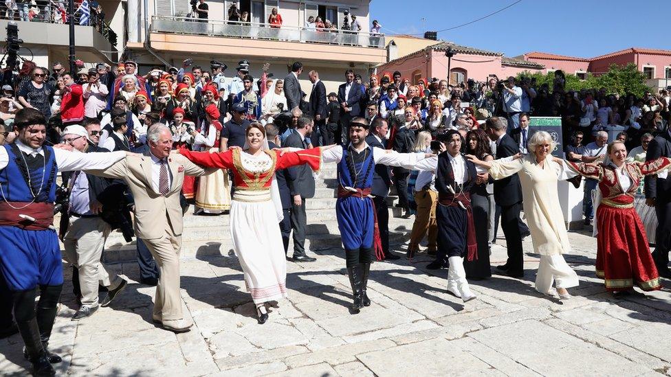 On a visit to Crete, Prince Charles and the Duchess of Cornwall take part in traditional dancing