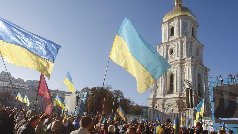 People pray on a square in front of Kiev's St Sophia Cathedral, Ukraine. Photo: 14 October 2018